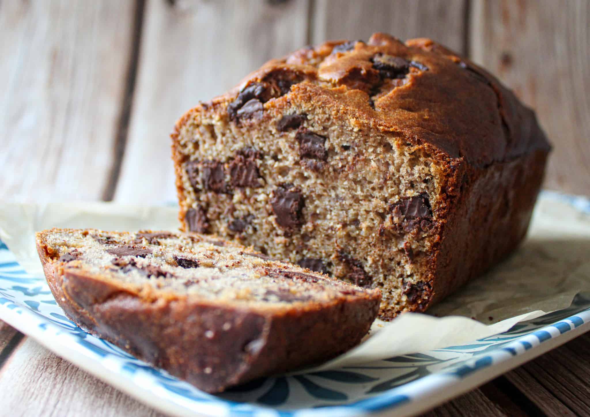 Buckwheat banana bread with one slice laying flat on a tray. 