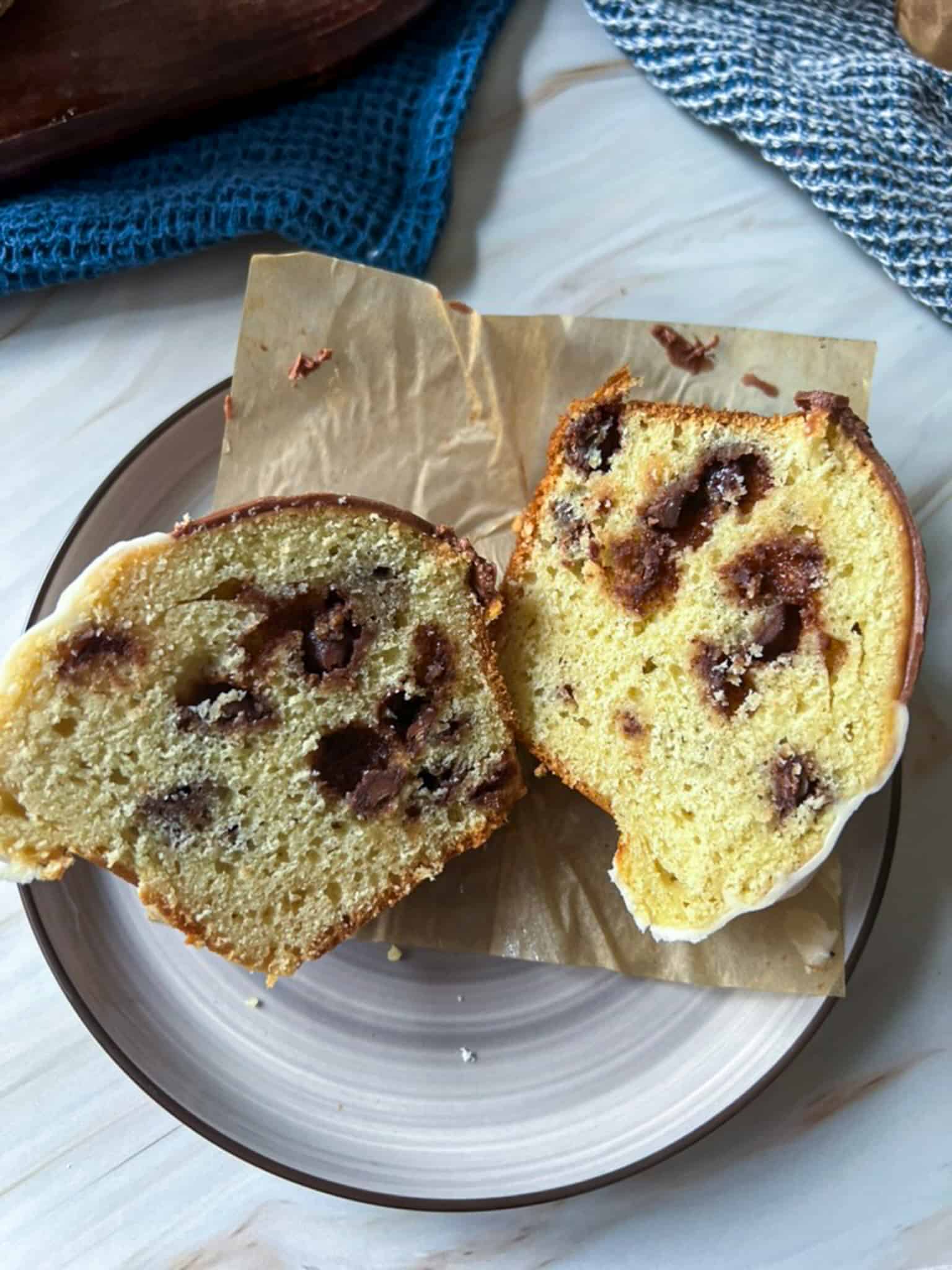 A black and white muffin cut in half on a plate. 