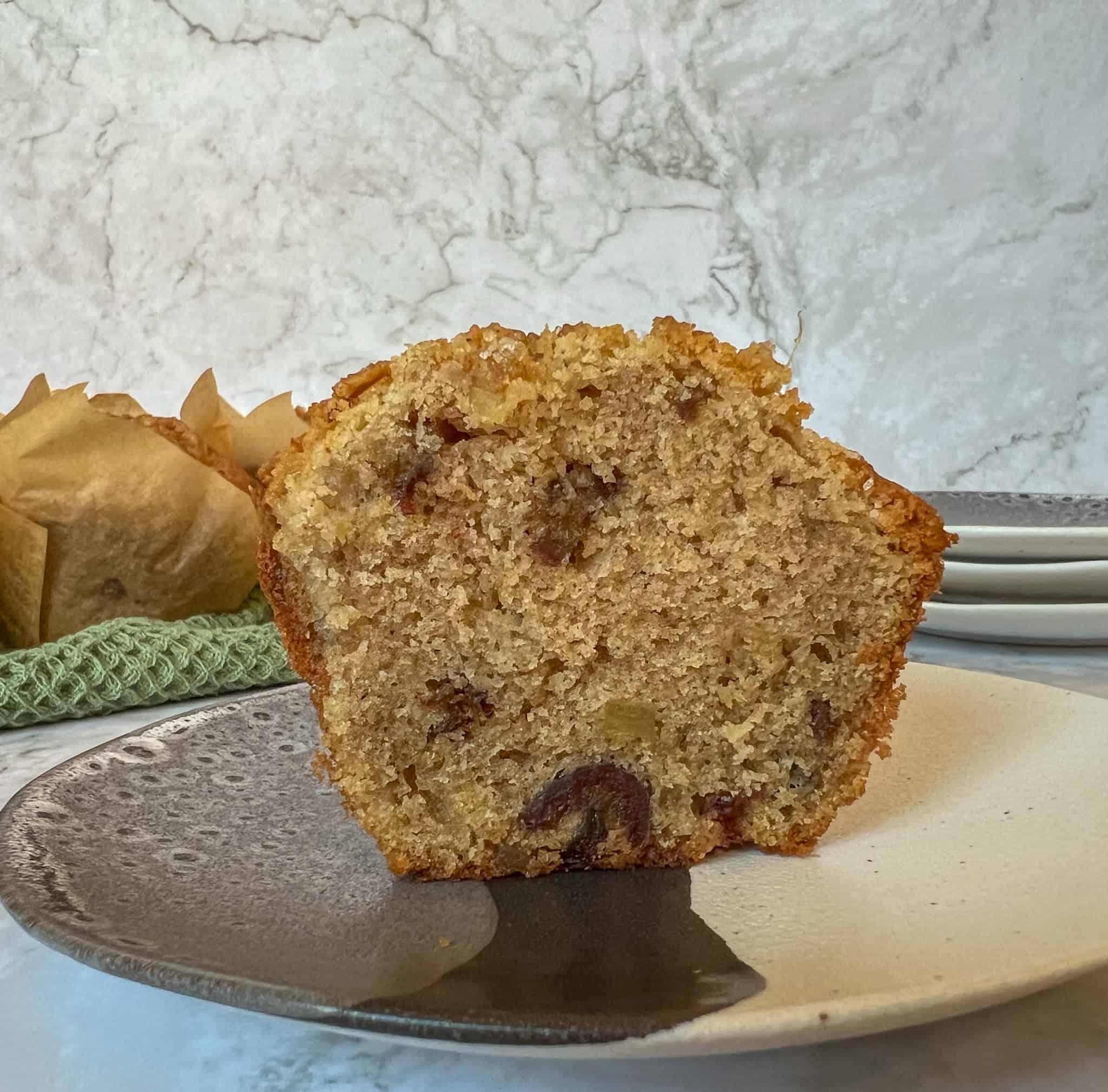 A buckwheat ginger muffin cut in half on a plate. 