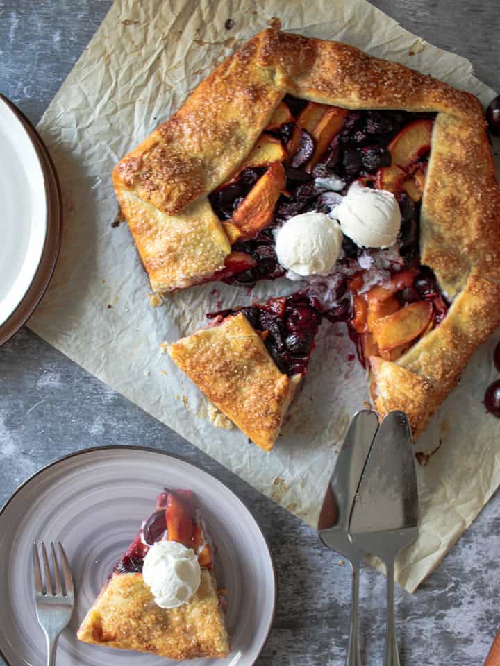 Cherry nectarine galette with a scoop of ice cream on top.