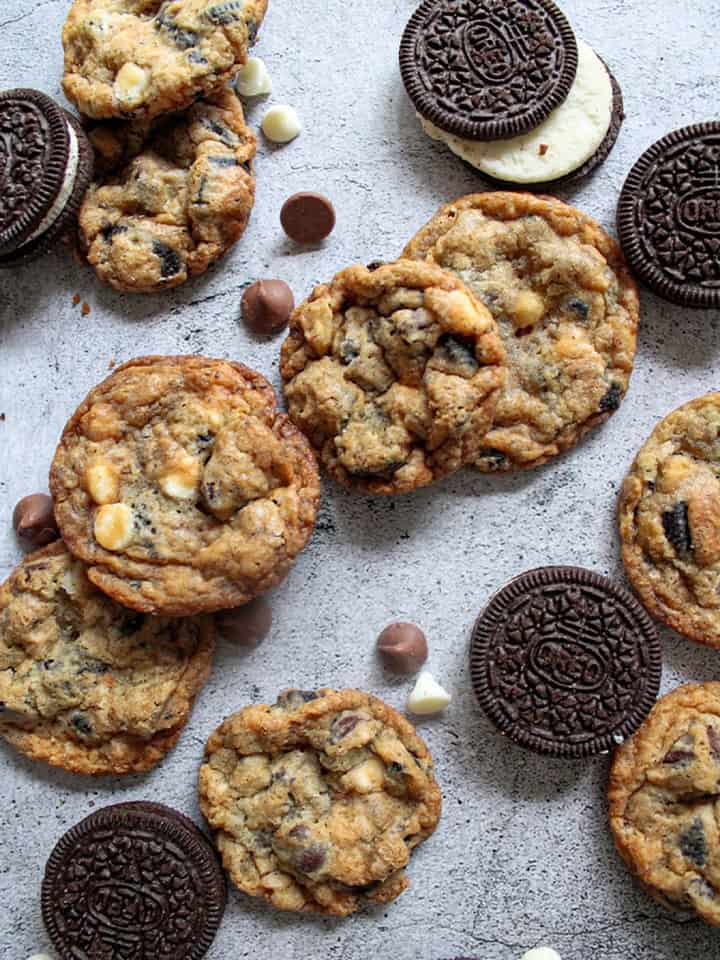 Cookies and Cream Cookies scattered with chocolate chips and Oreos.